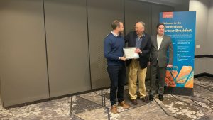 McKim & Creed's Robbie Eisenrich is presented with an award from Esri for McKim & Creed's 20-year partnership.