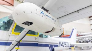 The AISPECO multi-sensor pod system is affixed to to a small aircraft ready for flight.