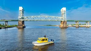 Cape Fear Memorial Bridge in the distance with a hydrographic survey boat on the Cape Fear River.